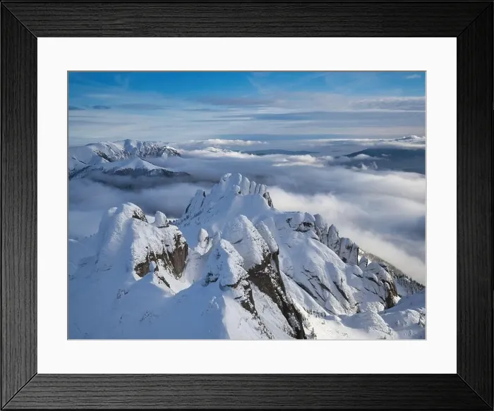 Framed Print : Aerial view of distant mountain peaks above clouds in clear sunny blue sky Framed Print : Aerial view of distant mountain peaks above clouds in clear sunny blue sky