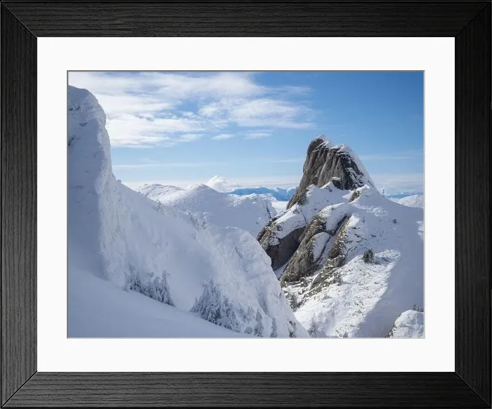 Framed Print : Aerial view of distant mountain peaks above clouds in clear sunny blue sky