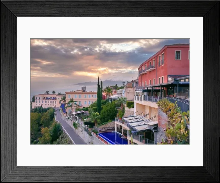 Framed Print : Taormina, Sicily, Italy. Cityscape image of picturesque town of Taormina, Sicily with volcano Mt. Etna in the background at sunset Framed Print : Taormina, Sicily, Italy. Cityscape image of picturesque town of Taormina, Sicily with volcano Mt. Etna in the background at sunset