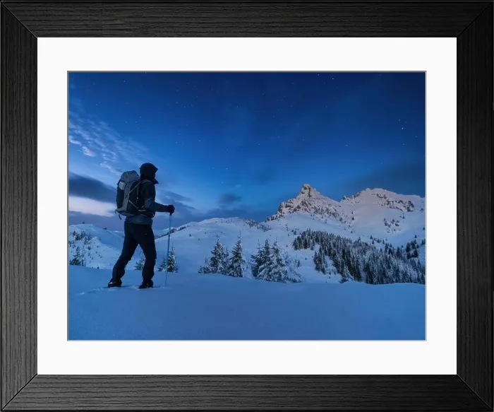 Framed Print : Night photo climber stands on top of a mountain in the snow and looks at the surrounding mountains with starry sky Framed Print : Night photo climber stands on top of a mountain in the snow and looks at the surrounding mountains with starry sky