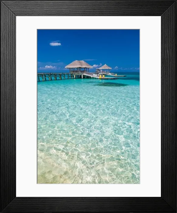 Framed Print : Tropical beach with water bungalows on the Maldives, amazing sea lagoon and seascape background. Exotic travel destination background Framed Print : Tropical beach with water bungalows on the Maldives, amazing sea lagoon and seascape background. Exotic travel destination background