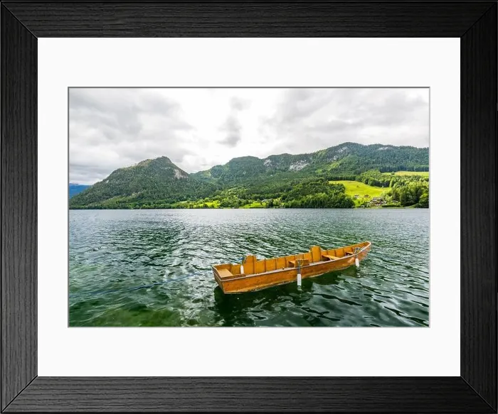 Framed Print : The Norwegian landscape with a boat on lake against mountains Framed Print : The Norwegian landscape with a boat on lake against mountains