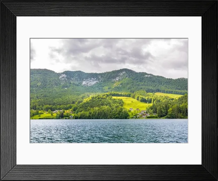Framed Print : Mountain lake near the Euopean alps with green forest and field, cloudy day Framed Print : Mountain lake near the Euopean alps with green forest and field, cloudy day