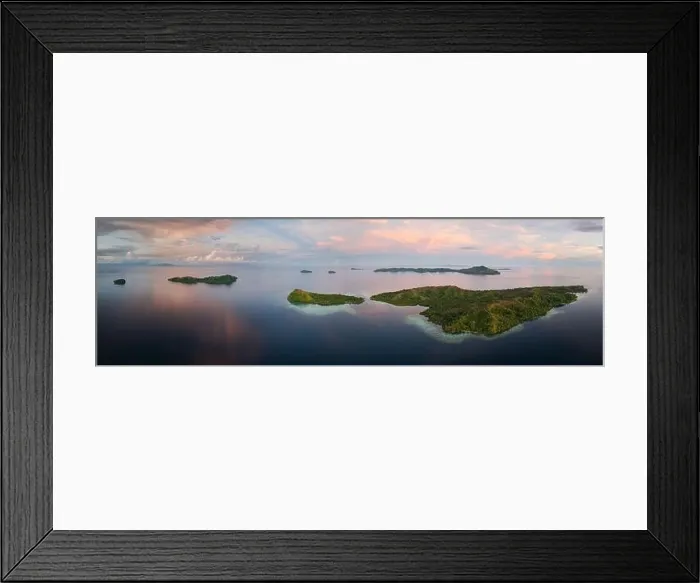Framed Print : Sunrise illuminates clouds that drift over the calm waters of the Solomon Islands. This scenic region is known for its high marine biodiversity Framed Print : Sunrise illuminates clouds that drift over the calm waters of the Solomon Islands. This scenic region is known for its high marine biodiversity
