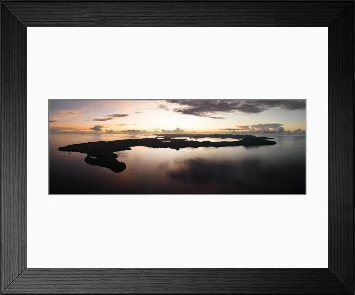 Framed Print : Sunrise illuminates clouds that drift over the calm waters of the Solomon Islands. This scenic region is known for its high marine biodiversity Framed Print : Sunrise illuminates clouds that drift over the calm waters of the Solomon Islands. This scenic region is known for its high marine biodiversity