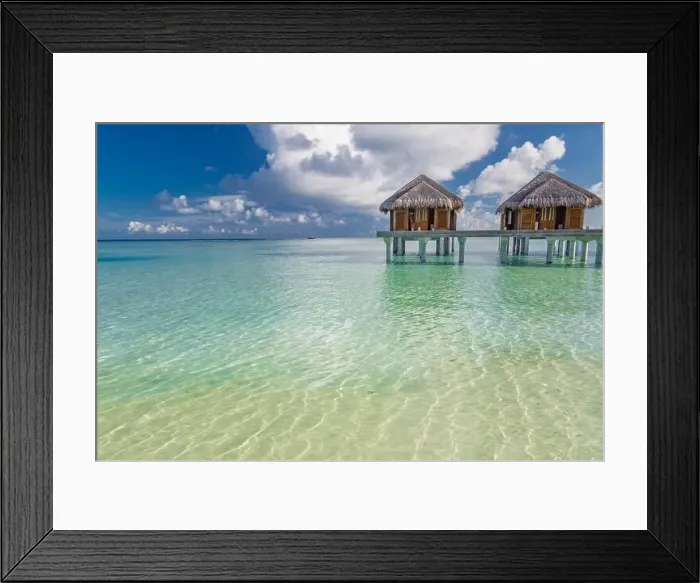 Framed Print : Tropical beach in Maldives with luxury over water bungalows or villas. Amazing sea lagoon with blue sky and clouds. Exotic travel destination Framed Print : Tropical beach in Maldives with luxury over water bungalows or villas. Amazing sea lagoon with blue sky and clouds. Exotic travel destination