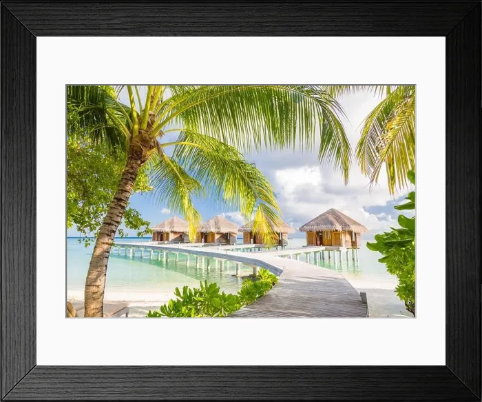 Framed Print : Beautiful tropical Maldives resort hotel water villas. Island with beach and palm leaves over sea on sky. Luxury holiday vacation background concept Framed Print : Beautiful tropical Maldives resort hotel water villas. Island with beach and palm leaves over sea on sky. Luxury holiday vacation background concept