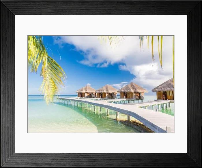 Framed Print : Beautiful tropical Maldives resort hotel water villas. Island with beach and palm leaves over sea on sky. Luxury holiday vacation background concept Framed Print : Beautiful tropical Maldives resort hotel water villas. Island with beach and palm leaves over sea on sky. Luxury holiday vacation background concept