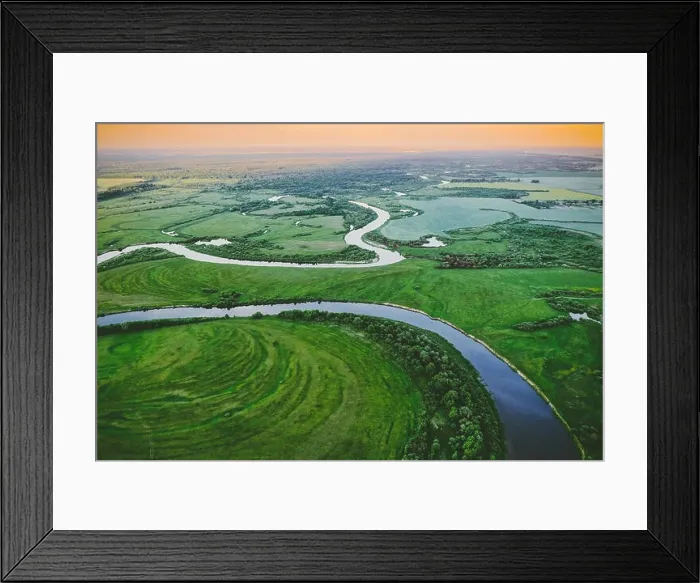Framed Print : Aerial View Green Meadow And River Landscape In Sunny Spring Evening. Top View Of Beautiful European Nature From High Attitude In Summer Season. Drone Framed Print : Aerial View Green Meadow And River Landscape In Sunny Spring Evening. Top View Of Beautiful European Nature From High Attitude In Summer Season. Drone