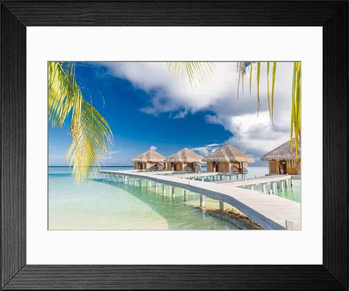 Framed Print : Beautiful tropical Maldives resort hotel water villas. Island with beach and palm leaves over sea on sky. Luxury holiday vacation background concept Framed Print : Beautiful tropical Maldives resort hotel water villas. Island with beach and palm leaves over sea on sky. Luxury holiday vacation background concept