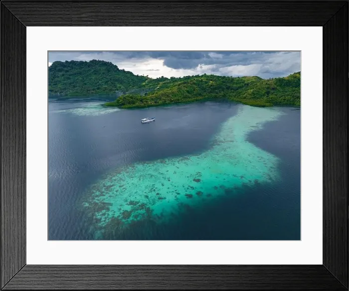 Framed Print : A scenic tropical island is fringed by a healthy coral reef in the Solomon Islands. This beautiful country is home to spectacular marine biodiversity Framed Print : A scenic tropical island is fringed by a healthy coral reef in the Solomon Islands. This beautiful country is home to spectacular marine biodiversity
