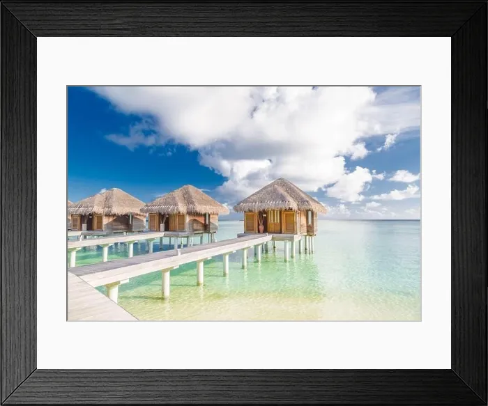 Framed Print : Tropical beach in Maldives with luxury over water bungalows or villas. Amazing sea lagoon with blue sky and clouds. Exotic travel destination