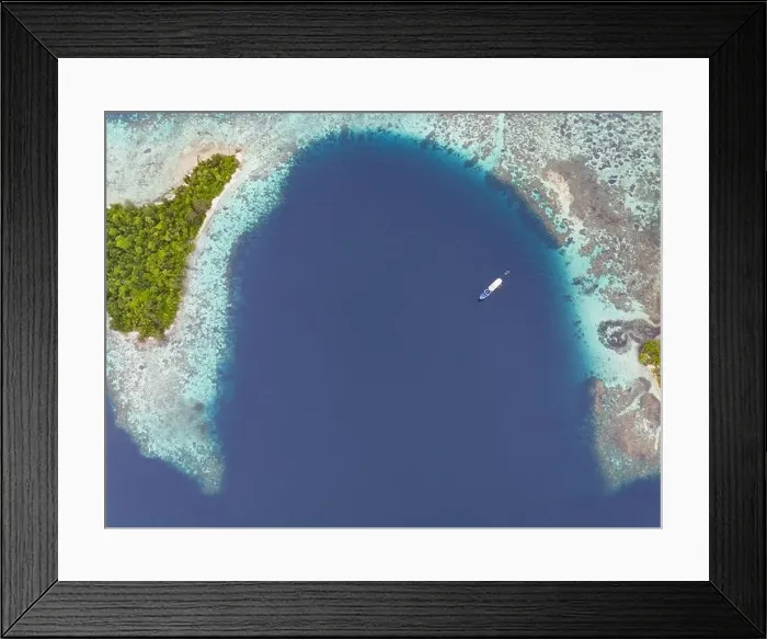 Framed Print : A healthy, robust coral reef surrounds a scenic bay in the Solomon Islands. This beautiful country is home to spectacular marine biodiversity