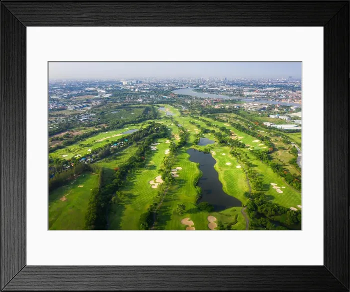 Framed Print : Aerial panoramic view drone shot of beautiful golf course with people playing golf in field and houses in city Framed Print : Aerial panoramic view drone shot of beautiful golf course with people playing golf in field and houses in city