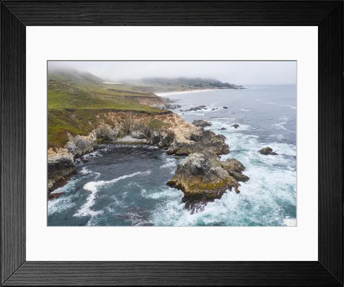 Framed Print : Seen from a bird's eye view, the cold waters of the Pacific Ocean wash against the rocky yet beautiful coast south of Monterey in Northern California Framed Print : Seen from a bird's eye view, the cold waters of the Pacific Ocean wash against the rocky yet beautiful coast south of Monterey in Northern California