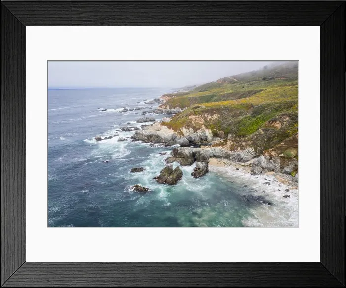 Framed Print : Seen from a bird's eye view, the cold waters of the Pacific Ocean wash against the rocky yet beautiful coast south of Monterey in Northern California Framed Print : Seen from a bird's eye view, the cold waters of the Pacific Ocean wash against the rocky yet beautiful coast south of Monterey in Northern California