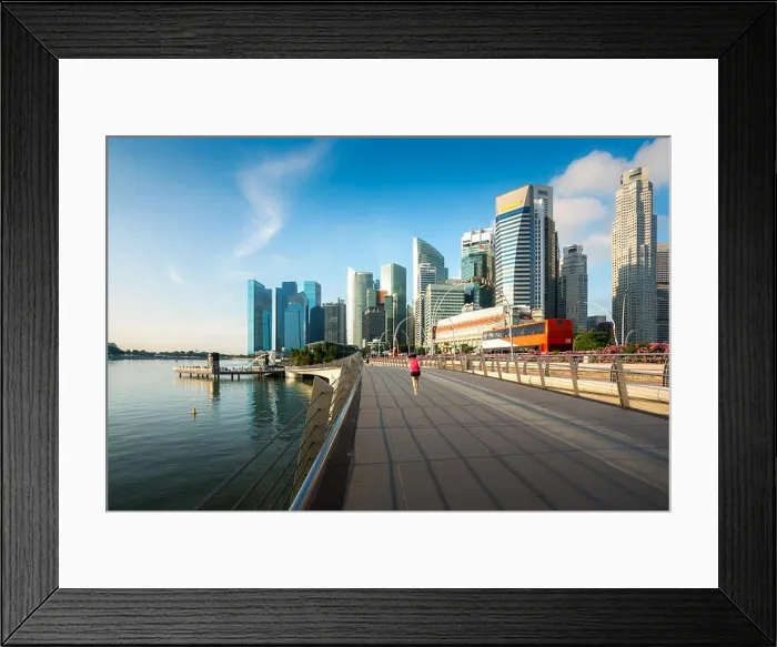 Framed Print : Pedestrians walk along bridge near Marina bay in Singapore with Singapore skyscraper in background Framed Print : Pedestrians walk along bridge near Marina bay in Singapore with Singapore skyscraper in background