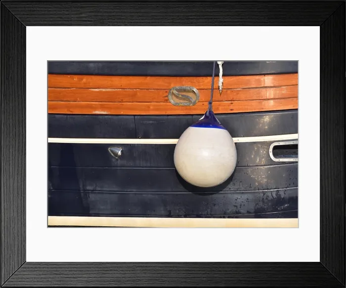Framed Print : A Fender (boating) hanging on the board to protect the side of the sailing vessel from the damage. Italy Framed Print : A Fender (boating) hanging on the board to protect the side of the sailing vessel from the damage. Italy