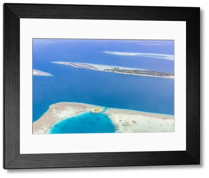 Framed Print : Aerial view of resort water bungalows. Luxury tropical hotel over coral reef connected with atolls in Indian ocean. Amazing travel landscape Framed Print : Aerial view of resort water bungalows. Luxury tropical hotel over coral reef connected with atolls in Indian ocean. Amazing travel landscape