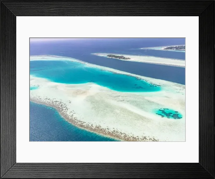Framed Print : Aerial view of resort water bungalows. Luxury tropical hotel over coral reef connected with atolls in Indian ocean. Amazing travel landscape Framed Print : Aerial view of resort water bungalows. Luxury tropical hotel over coral reef connected with atolls in Indian ocean. Amazing travel landscape