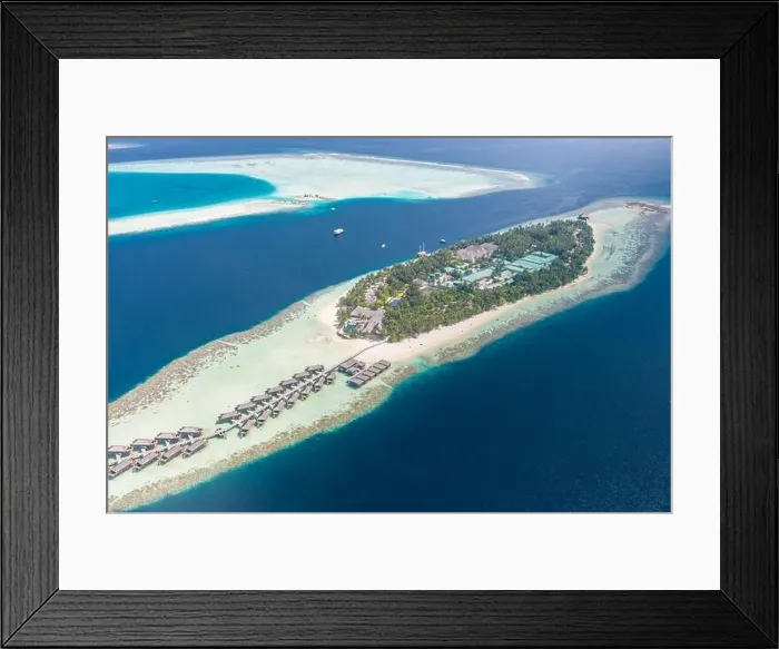 Framed Print : Aerial view of a tropical island in turquoise water. Luxurious over-water villas on tropical island resort Maldives for holiday vacation background Framed Print : Aerial view of a tropical island in turquoise water. Luxurious over-water villas on tropical island resort Maldives for holiday vacation background
