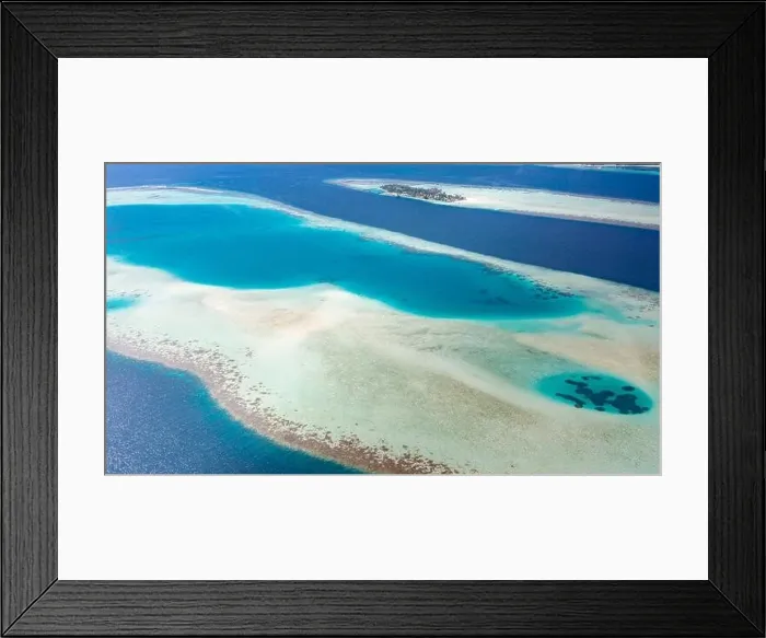 Framed Print : Aerial view of a tropical island in turquoise water. Luxurious over-water villas on tropical island resort Maldives for holiday vacation background