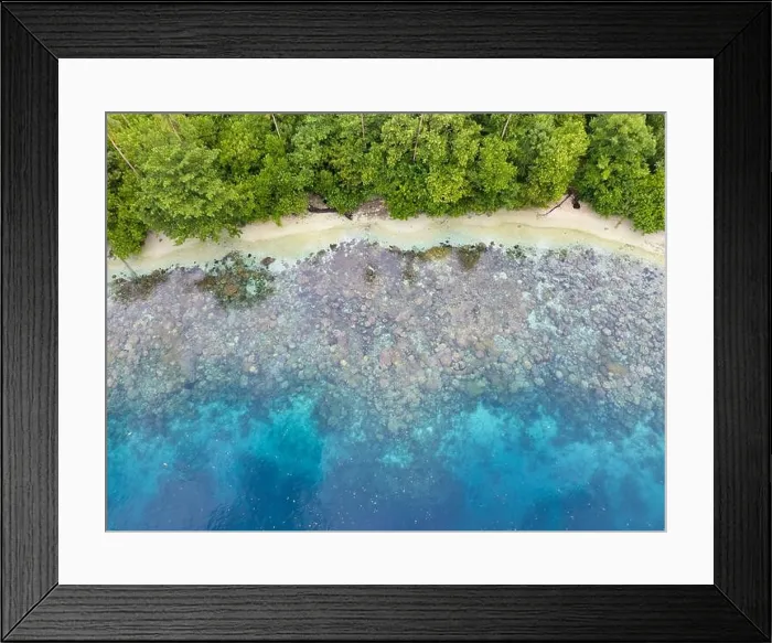 Framed Print : A lush, tropical island is fringed by a coral reef in the Solomon Islands. This beautiful country is home to spectacular marine biodiversity Framed Print : A lush, tropical island is fringed by a coral reef in the Solomon Islands. This beautiful country is home to spectacular marine biodiversity
