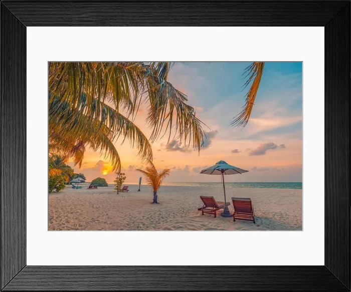 Framed Print : Tranquil tropical sunset landscape, couple sun beds, loungers, umbrella under palm leaves colorful twilight sky. Romance love honeymoon concept