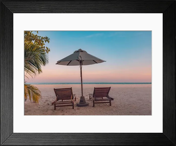 Framed Print : Tranquil tropical sunset landscape, couple sun beds, loungers, umbrella under palm leaves colorful twilight sky. Romance love honeymoon concept Framed Print : Tranquil tropical sunset landscape, couple sun beds, loungers, umbrella under palm leaves colorful twilight sky. Romance love honeymoon concept