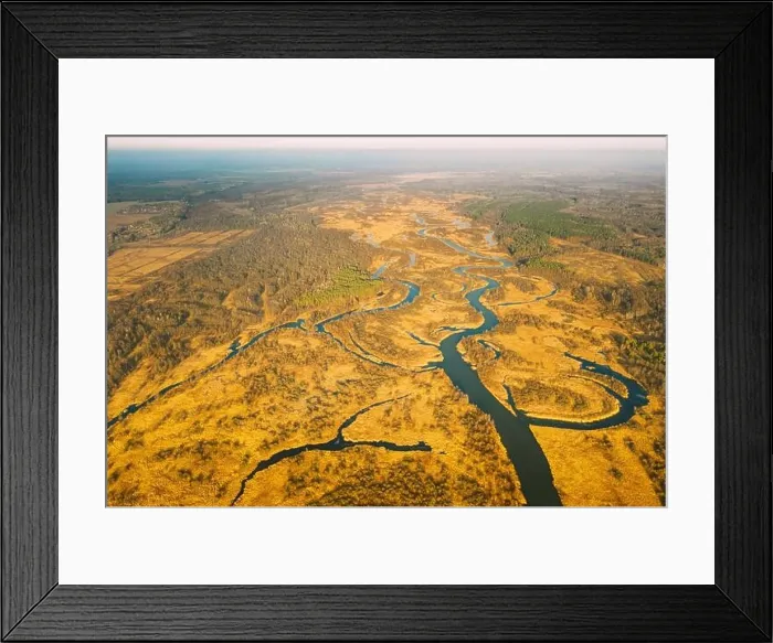 Framed Print : Belarus. Aerial View Of Dry Grass And Partly Frozen Curved River Landscape In Late Autumn Day. High Attitude View. Marsh Bog. Drone View. Bird's Eye V Framed Print : Belarus. Aerial View Of Dry Grass And Partly Frozen Curved River Landscape In Late Autumn Day. High Attitude View. Marsh Bog. Drone View. Bird's Eye V
