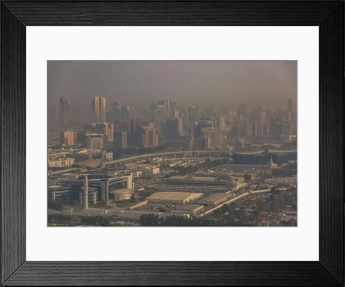 Framed Print : DUBAI, UAE - APRIL 29: Aerial view of Downtown Dubai and skyscrapers during morning sandstorm. Highway and trainline, soft light over the sand