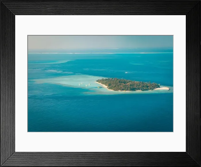 Framed Print : Tropical islands and atolls in Maldives from aerial view. Famous travel destination and luxury vacation or summer holiday concept. Aerial landscape Framed Print : Tropical islands and atolls in Maldives from aerial view. Famous travel destination and luxury vacation or summer holiday concept. Aerial landscape
