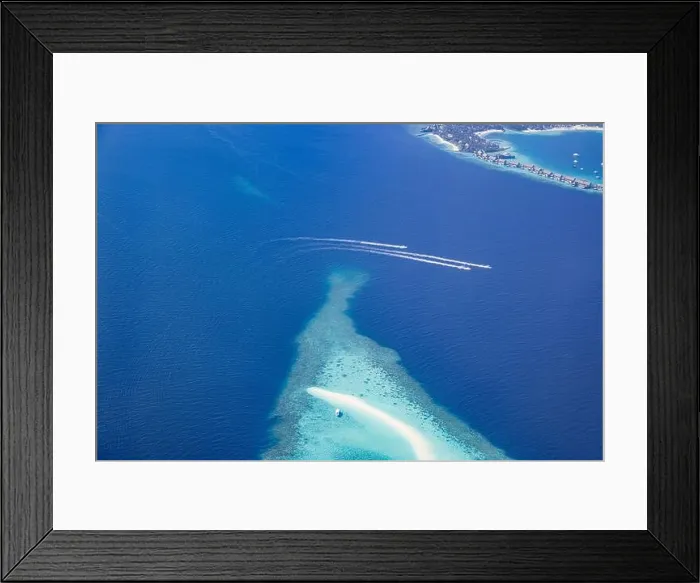 Framed Print : Landscape seascape aerial view over Maldives luxury resort villas with atoll sandbank island. Jet skis having fun in ocean lagoon. Luxurious summer Framed Print : Landscape seascape aerial view over Maldives luxury resort villas with atoll sandbank island. Jet skis having fun in ocean lagoon. Luxurious summer