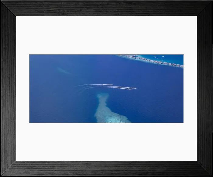 Framed Print : Landscape seascape aerial view over Maldives luxury resort villas with atoll sandbank island. Jet skis having fun in ocean lagoon. Luxurious summer Framed Print : Landscape seascape aerial view over Maldives luxury resort villas with atoll sandbank island. Jet skis having fun in ocean lagoon. Luxurious summer