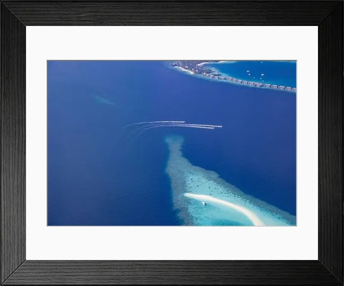 Framed Print : Landscape seascape aerial view over Maldives luxury resort villas with atoll sandbank island. Jet skis having fun in ocean lagoon. Luxurious summer Framed Print : Landscape seascape aerial view over Maldives luxury resort villas with atoll sandbank island. Jet skis having fun in ocean lagoon. Luxurious summer