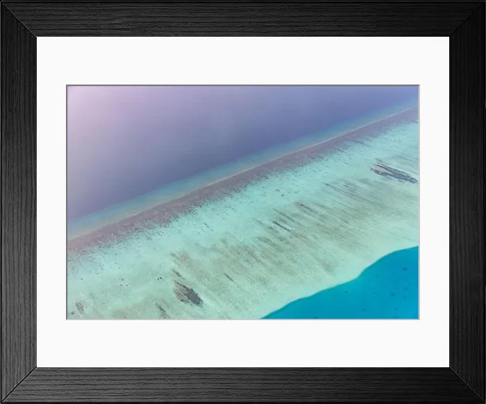Framed Print : Tropical islands and atolls in Maldives from aerial view. Famous travel destination and luxury vacation or summer holiday concept. Aerial landscape Framed Print : Tropical islands and atolls in Maldives from aerial view. Famous travel destination and luxury vacation or summer holiday concept. Aerial landscape
