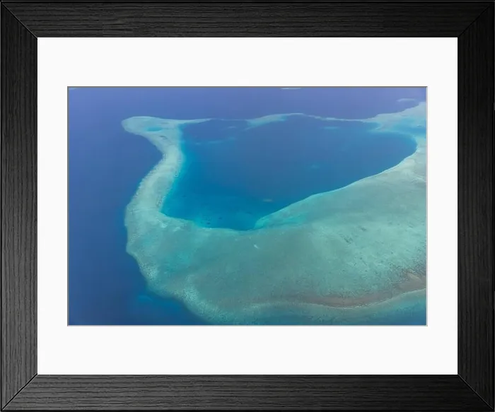 Framed Print : Tropical islands and atolls in Maldives from aerial view. Famous travel destination and luxury vacation or summer holiday concept. Aerial landscape Framed Print : Tropical islands and atolls in Maldives from aerial view. Famous travel destination and luxury vacation or summer holiday concept. Aerial landscape