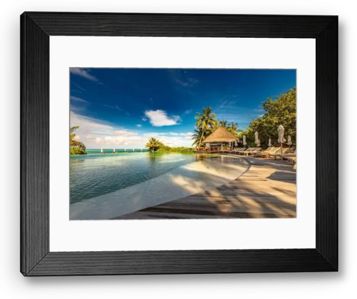 Framed Print : Luxury beach swimming pool at sunset with reflection of palm trees, tropical landscape, exotic island hotel. Loungers and chairs with closed umbrella Framed Print : Luxury beach swimming pool at sunset with reflection of palm trees, tropical landscape, exotic island hotel. Loungers and chairs with closed umbrella