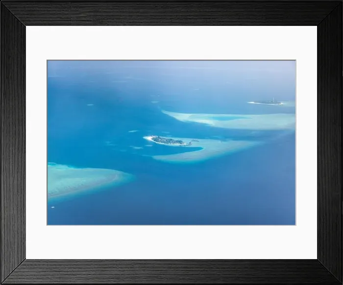 Framed Print : Tropical islands and atolls in Maldives from aerial view. Famous travel destination and luxury vacation or summer holiday concept. Aerial landscape Framed Print : Tropical islands and atolls in Maldives from aerial view. Famous travel destination and luxury vacation or summer holiday concept. Aerial landscape