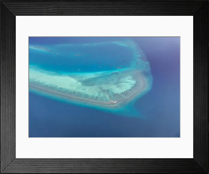 Framed Print : Tropical islands and atolls in Maldives from aerial view. Famous travel destination and luxury vacation or summer holiday concept. Aerial landscape Framed Print : Tropical islands and atolls in Maldives from aerial view. Famous travel destination and luxury vacation or summer holiday concept. Aerial landscape
