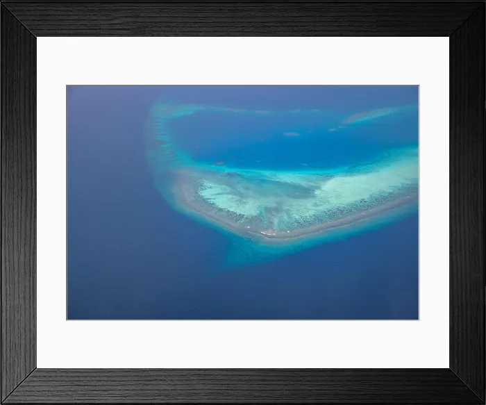 Framed Print : Tropical islands and atolls in Maldives from aerial view. Famous travel destination and luxury vacation or summer holiday concept. Aerial landscape Framed Print : Tropical islands and atolls in Maldives from aerial view. Famous travel destination and luxury vacation or summer holiday concept. Aerial landscape