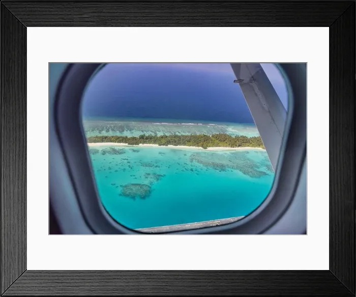 Framed Print : Airplane window with beautiful Maldives island view. Luxury summer holiday travel tourism background, view from airplane window. Atolls islands Framed Print : Airplane window with beautiful Maldives island view. Luxury summer holiday travel tourism background, view from airplane window. Atolls islands