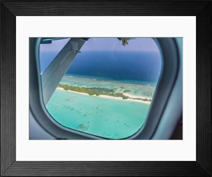 Framed Print : Airplane window with beautiful Maldives island view. Luxury summer holiday travel tourism background, view from airplane window. Atolls islands Framed Print : Airplane window with beautiful Maldives island view. Luxury summer holiday travel tourism background, view from airplane window. Atolls islands