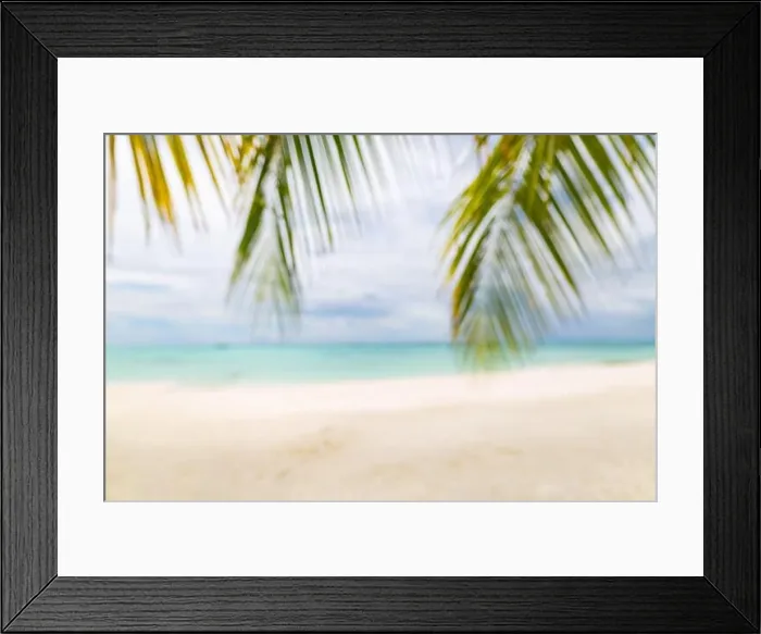 Framed Print : Summer exotic sandy beach with blur palms and sea on background. Dream vacation background with palm leaves and sea view. Summer paradise island beach Framed Print : Summer exotic sandy beach with blur palms and sea on background. Dream vacation background with palm leaves and sea view. Summer paradise island beach