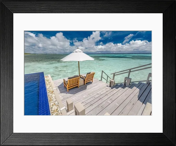 Framed Print : Luxury swimming pool in over water villa with beach chairs and umbrella. Amazing summer vibes, sea view and luxurious couple scene. Tropical paradise Framed Print : Luxury swimming pool in over water villa with beach chairs and umbrella. Amazing summer vibes, sea view and luxurious couple scene. Tropical paradise