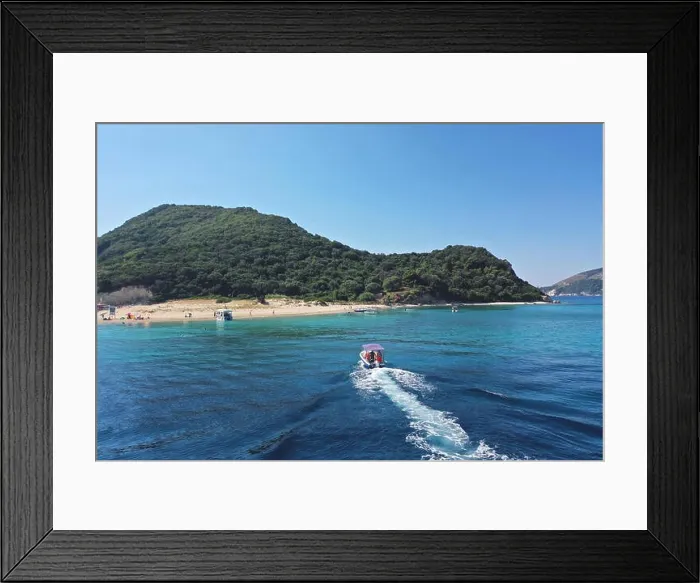 Framed Print : Small boat with tourists heading to iconic small uninhabited island of Marathonisi featuring clear water sandy shore and natural hatchery of Caretta-C Framed Print : Small boat with tourists heading to iconic small uninhabited island of Marathonisi featuring clear water sandy shore and natural hatchery of Caretta-C