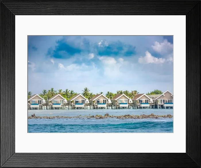 Framed Print : Luxury vacation in Maldives with water bungalows and palm trees background on tropical island. Exotic travel destination Framed Print : Luxury vacation in Maldives with water bungalows and palm trees background on tropical island. Exotic travel destination