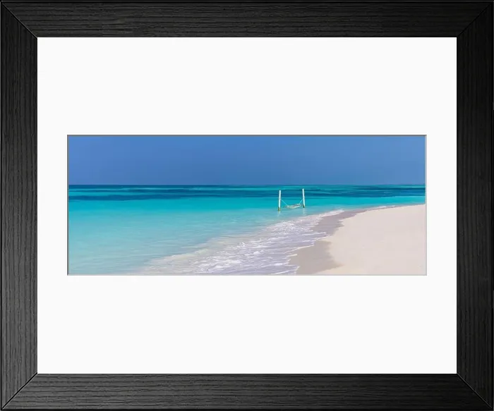 Framed Print : Luxury beach. Tranquil travel background. Summer vacation or holiday concept on tropical beach white sand and amazing over water hammock over blue bay Framed Print : Luxury beach. Tranquil travel background. Summer vacation or holiday concept on tropical beach white sand and amazing over water hammock over blue bay