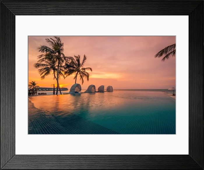 Framed Print : Luxury pool sunset, palm tree silhouette with windy infinity pool water surface. Summer vacation, holiday template. Stunning sky, beachfront resort Framed Print : Luxury pool sunset, palm tree silhouette with windy infinity pool water surface. Summer vacation, holiday template. Stunning sky, beachfront resort