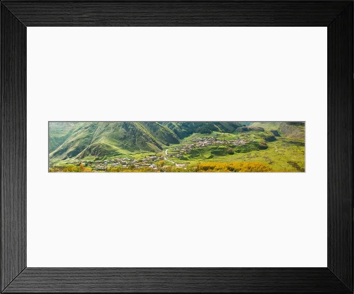 Framed Print : Stepantsminda Village At Evening In Kazbegi District, Mtskheta-Mtianeti Region, Georgia. Sunny Day At Spring Or Summer Season. Panorama Framed Print : Stepantsminda Village At Evening In Kazbegi District, Mtskheta-Mtianeti Region, Georgia. Sunny Day At Spring Or Summer Season. Panorama